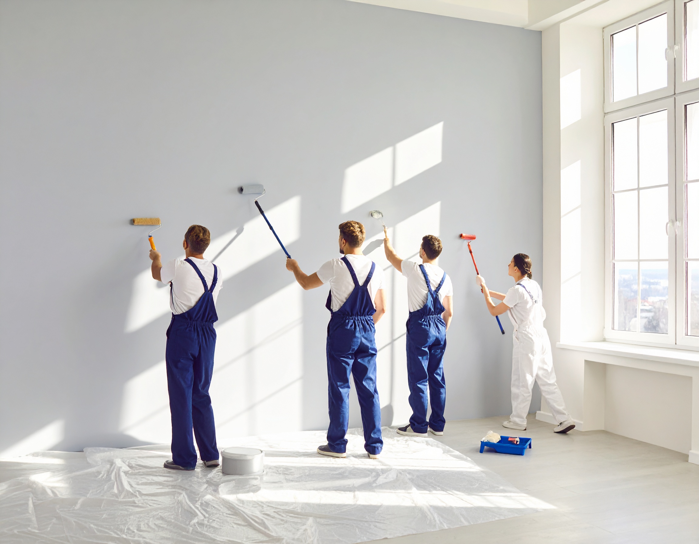 Des ouvriers en train de faire des travaux de peinture intérieure dans une maison